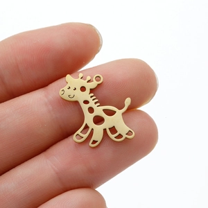 Hand holding a gold stainless steel giraffe pendant with hollow-out pattern and round ring