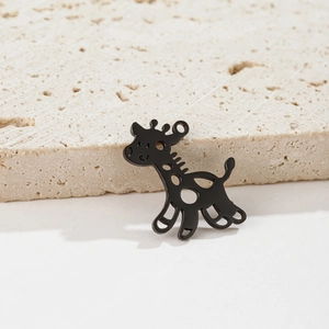 Detail shot of a minimalist black stainless steel giraffe pendant on a stone base