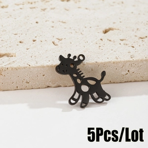Close-up of five black cartoon giraffe pendants on a textured beige stone background