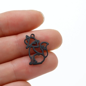 Black hollow fox origami pendant in matte finish held by hand showing small size