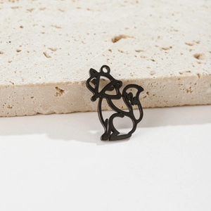 Macro shot of matte black stainless steel origami fox pendant on stone surface