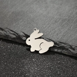 Polished stainless steel rabbit charm pendant for DIY jewelry making on stone surface