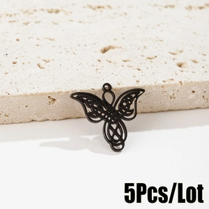 Detailed close-up of 5-piece set gothic black hollow butterfly pendants on stone