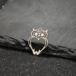 Polished stainless steel owl pendant with hollow heart design on black slate stone