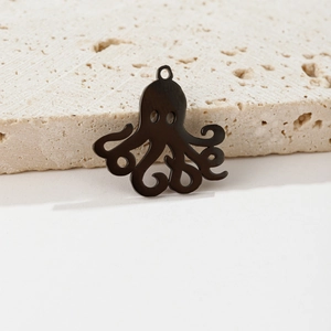 Macro detail of black stainless steel octopus charm with matte finish and hollow design