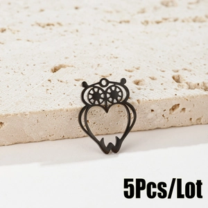 Macro shot of black hollow owl pendant with heart-shaped body and gear eyes 5pcs set