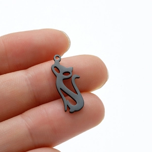 Close-up of minimalist black cat pendant charm made of stainless steel for DIY jewelry