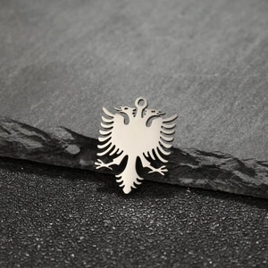 Macro shot of silver double-headed eagle pendant with detailed heraldic engraving