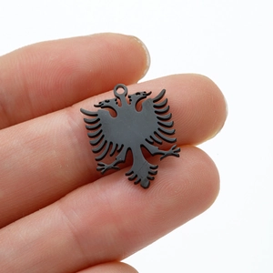 Detail of a matte black eagle pendant with intricate hollowed-out double-headed design