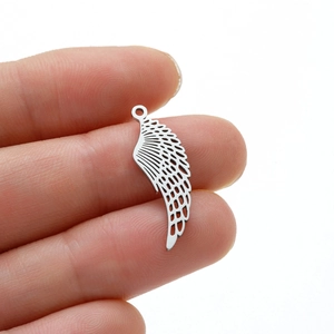 Stainless steel hollow angel wing charm pendant with feather detail held by hand