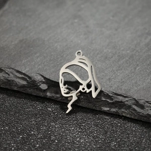 Close-up of Girl with a Pearl Earring hollow out metal pendant on dark stone surface