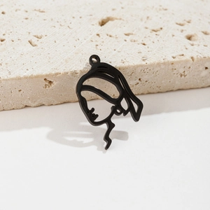Detailed view of black stainless steel cutout pendant featuring a female silhouette