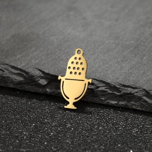 Detailed view of a gold microphone pendant charm for DIY jewelry making on slate background