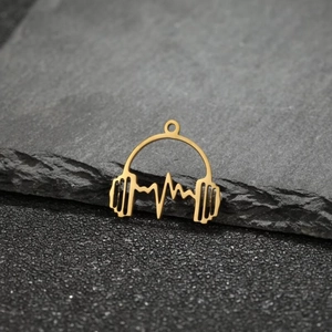 Macro shot of a polished gold mini headphone pendant with heartbeat line design