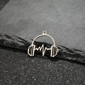 Macro detail of silver stainless steel headphone pendant with heartbeat line design