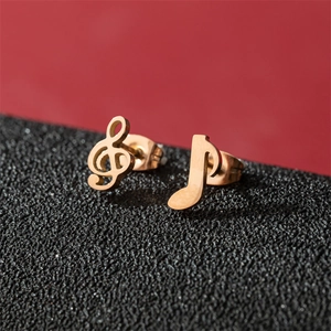 Asymmetric stainless steel music note stud earrings in polished gold finish