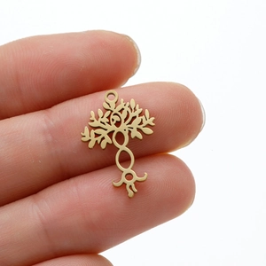Golden Tree of Life stainless steel pendant on fingertip showing scale and detail