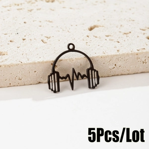 Macro detail of black matte headphone pendant with heart rate wave design for DIY jewelry