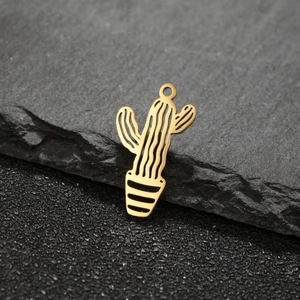 Macro shot of gold-plated stainless steel cactus charms on a dark slate background