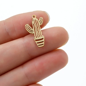Golden stainless steel cactus charm pendant for DIY jewelry on a person's finger