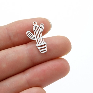 Polished stainless steel cactus plant pendant for necklaces held by fingers on white background