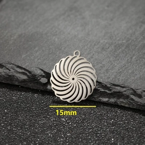 Silver stainless steel 15mm hollow swirling flower pendant on a natural stone background
