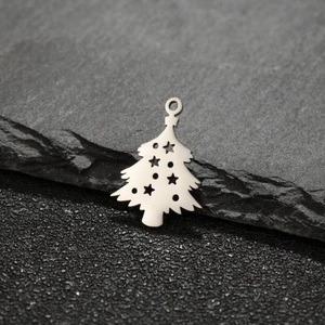 Macro shot of silver stainless steel Christmas tree pendant with star cut-outs on stone