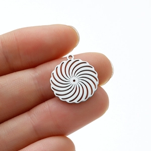 Macro shot of silver stainless steel swirl pendant for DIY jewelry making and necklaces