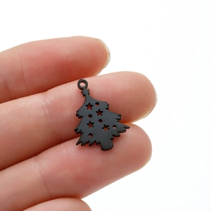Close-up of black matte stainless steel Christmas tree pendant with star cutout detail