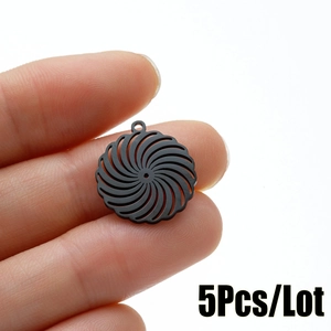 Detail of 5pcs pack black stainless steel hollow spiral flower pendants held by hand