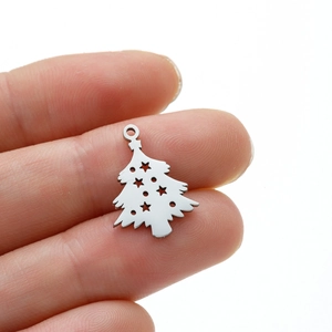 Macro detail of silver stainless steel cutout Christmas tree pendant with star shapes