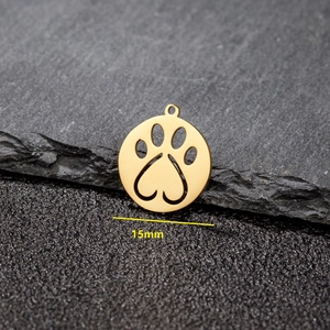 Minimalist gold stainless steel 15mm hollow paw pendant necklace on dark stone background