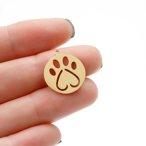 Close-up of geometric circular necklace pendant with hollow heart and pet paw print detail