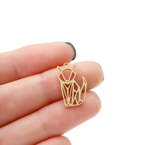 Minimalist gold origami fox pendant with hollow geometric design held in hand