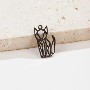Macro shot of minimalist matte black geometric origami fox pendant on beige travertine stone