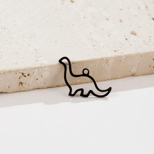 Detail of matte black dinosaur pendant on stone base showing minimalist hollow cut-out design