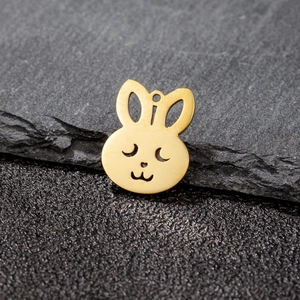 Close-up of golden hollow rabbit pendant with smooth finish and top hanging hole