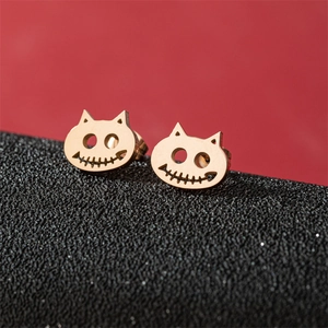 Rose gold stainless steel skeleton cat stud earrings for Halloween on red background