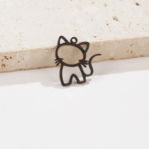 Détail macro d'un pendentif chat noir en acier inoxydable sur un support en pierre texturée