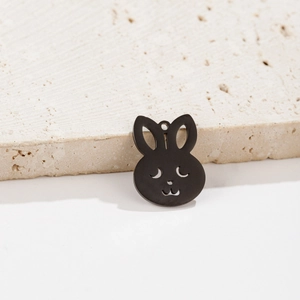 Detail of matte black rabbit shaped stainless steel pendant with hollow eye and mouth design
