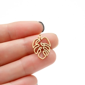 Detail view of a hollow monstera leaf pendant in gold stainless steel for DIY jewelry making