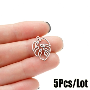 Macro shot of silver monstera leaf charms for DIY jewelry making set of five pieces