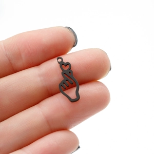 Detail view of a matte black finger heart gesture pendant for DIY jewelry making