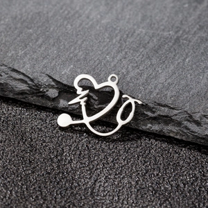 Macro shot of silver stainless steel stethoscope heart pendant with polished finish