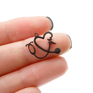 Close-up of black matte heart stethoscope pendant held to show actual small scale