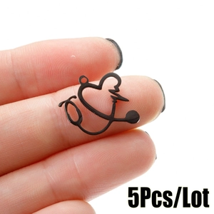 Macro detail of 5 black stainless steel stethoscope heart pendants for DIY jewelry