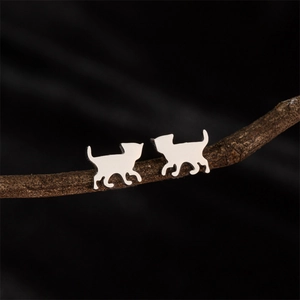 Polished stainless steel cat silhouette stud earrings displayed on a natural branch