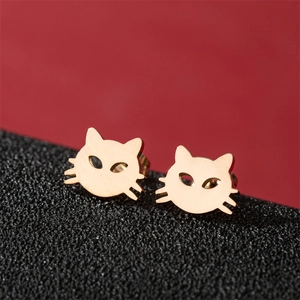 Polished gold stainless steel cat-shaped stud earrings on elegant textured display