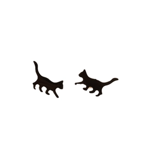 Asymmetric black cat stud earrings with a sleek glossy finish on a clean white background