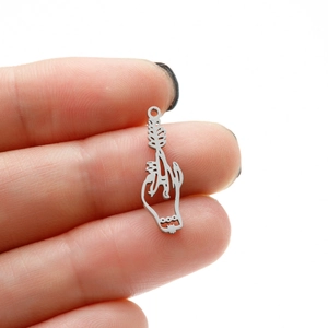 Close-up of a silver gothic hand pendant with leaf textures for DIY jewelry crafting